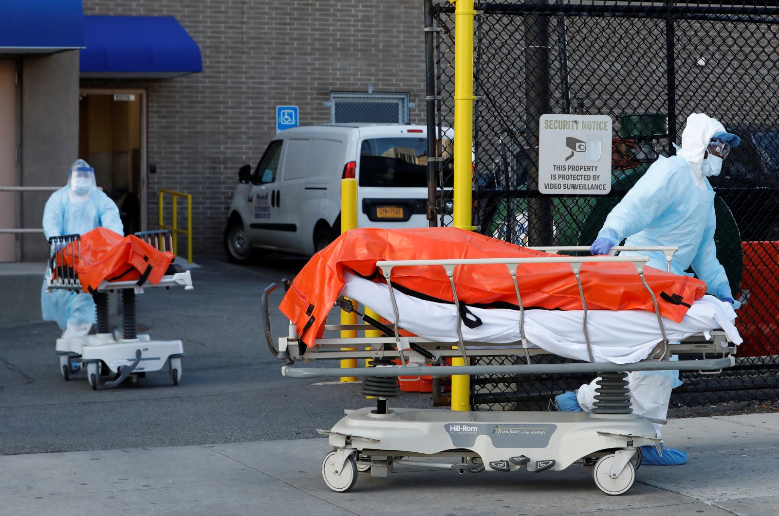 Health care workers wheel the bodies of deceased people from the Wyckoff Heights Medical Center during the outbreak of the coronavirus in the Brooklyn borough of New York City, New York, U.S., Saturday, April 4, 2020. (Reuters Photo)