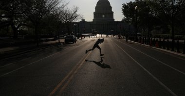 A child runs across East Capitol Street, a normally busy street outside of the U.S. Capitol building as the spread of the coronavirus continues in Washington D.C., U.S., Monday, April 6, 2020. (Reuters Photo)