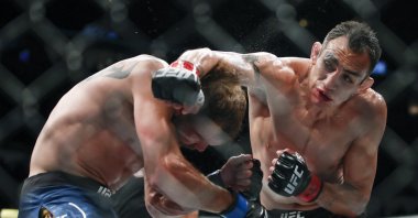 Tony Ferguson (R) punches Donald Cerrone during their lightweight mixed martial arts bout at UFC 238 in Chicago, Illinois., U.S., June 8, 2019. (AP Photo)