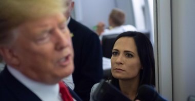 Former White House press secretary Stephanie Grisham listens as U.S. President Donald Trump speaks to the media aboard Air Force One while flying between El Paso, Texas and Joint Base Andrews in Maryland, Aug. 7, 2019. (AFP Photo)