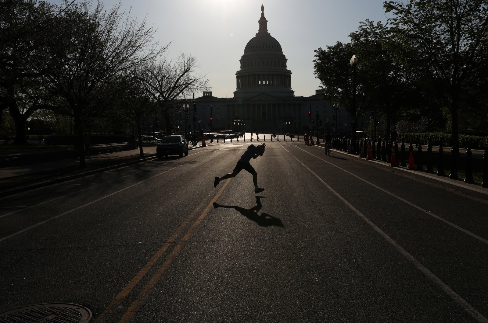 A child runs across East Capitol Street, a normally busy street outside of the U.S. Capitol building as the spread of the coronavirus continues in Washington D.C., U.S., Monday, April 6, 2020. (Reuters Photo)