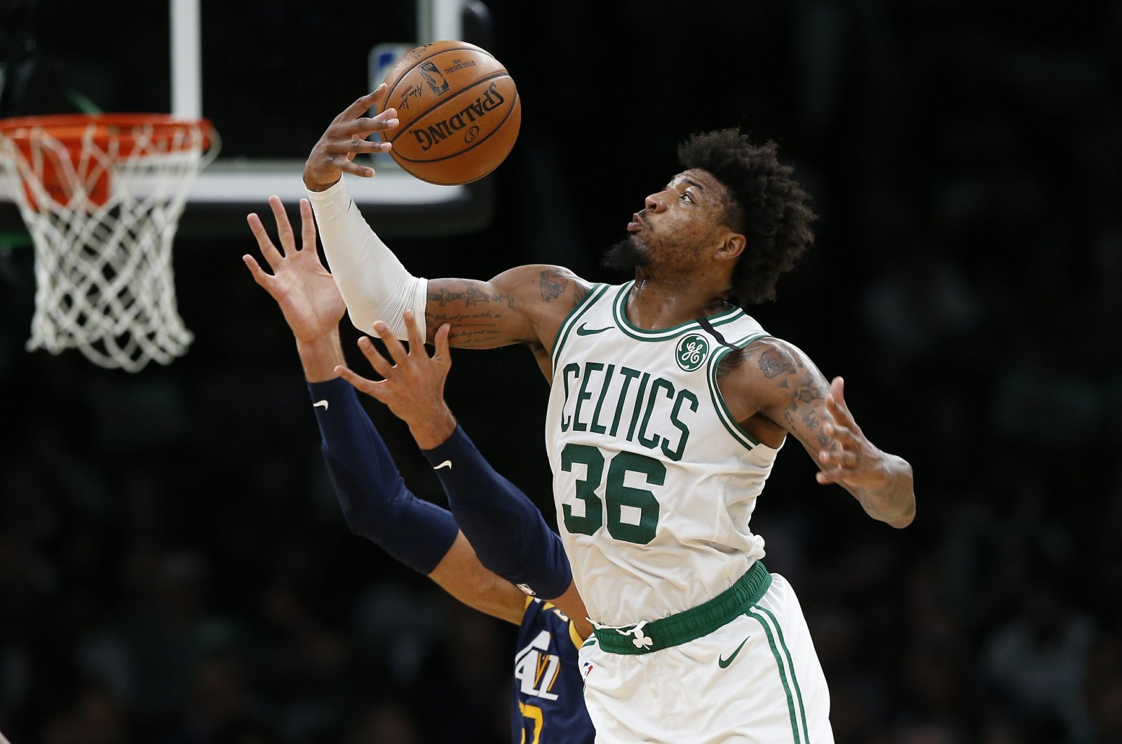 Boston Celtics' Marcus Smart (36) gathers in a rebound against the Utah Jazz during an NBA game, in Boston, March 6, 2020. (AP Photo)