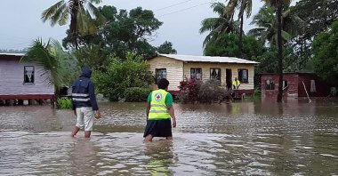 Rescue workers make their way through a village during flooding caused by Tropical Cyclone Harold in Nasolo in Fiji, Wednesday, April 8, 2020. (AFP Photo)