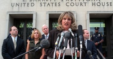 In this July 29, 1998, file photo Linda Tripp meets with reporters outside federal court in Washington after her final appearance before a grand jury investigating an alleged affair between President Bill Clinton and Monica Lewinsky. (AP Photo)