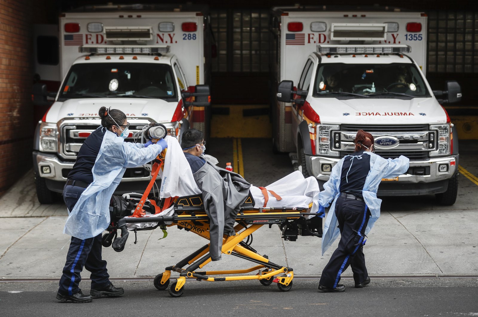 Patients are brought into Wyckoff Heights Medical Center by staff wearing personal protective gear due to COVID-19 concerns, Tuesday, April 7, 2020, in the Brooklyn borough of New York. (AP Photo)