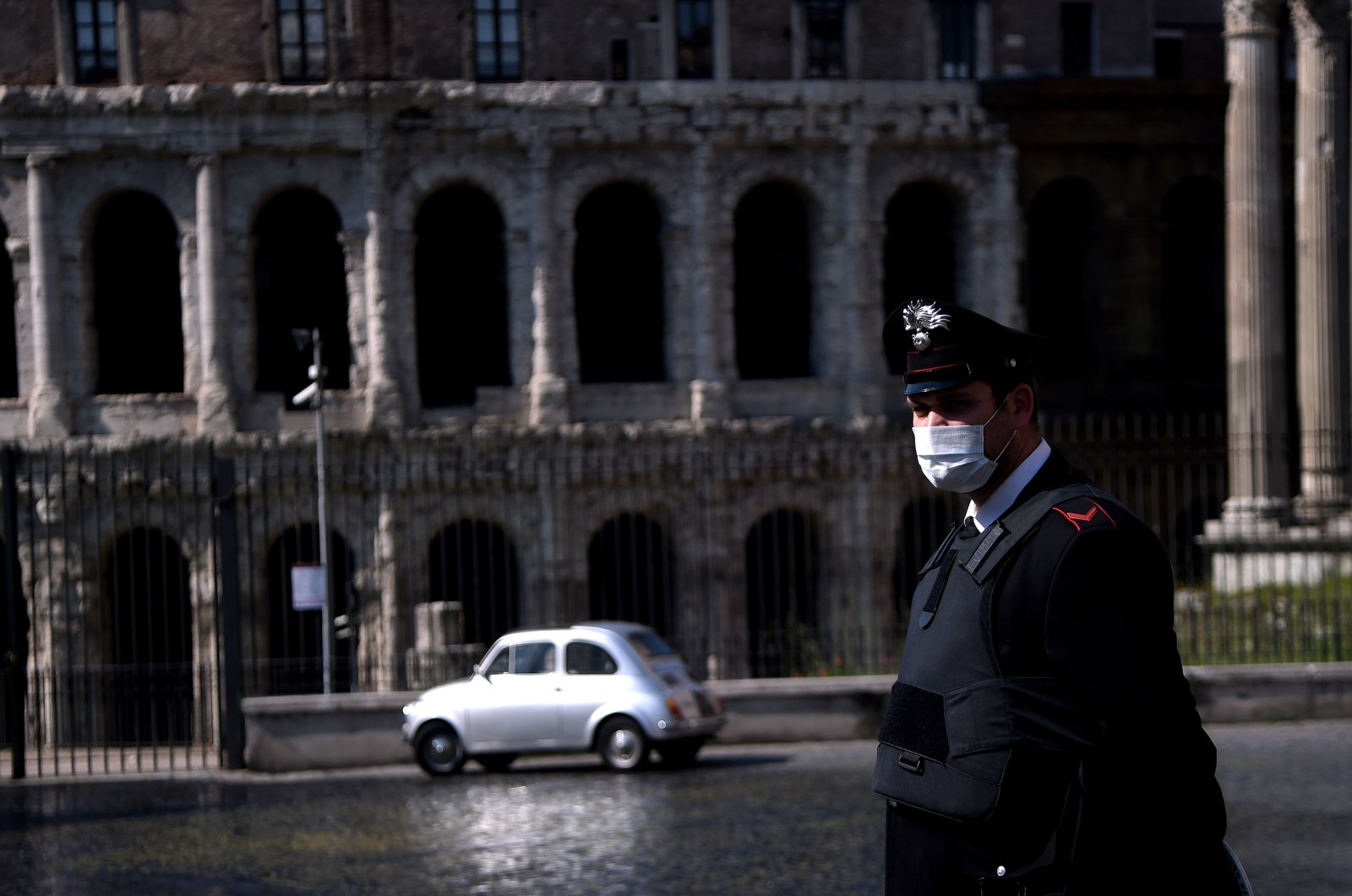 An Italian Carabiniere patrols by the Teatro di Marcello, Rome, April 8, 2020. (AFP Photo)