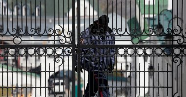 A security guard wearing a protective face mask is seen at the gate of Kyiv Pechersk Lavra monastery during the COVID-19 outbreak in Kyiv, Ukraine, Thursday, April 9, 2020. (Reuters Photo)