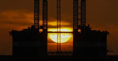 The sun rises on the horizon as seen behind an oil well in Las Palmas, Gran Canaria, Spain, April 5, 2020. (EPA Photo)