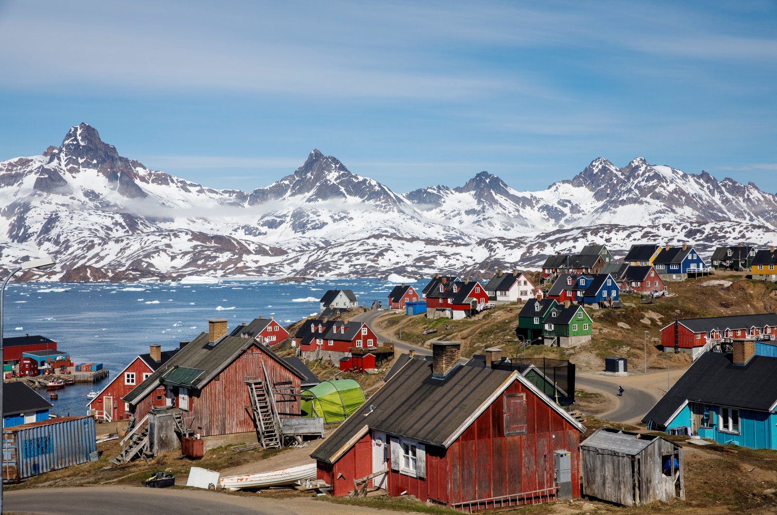 Snow covered mountains rise above the harbor and town of Tasiilaq, Greenland, June 15, 2018. (Reuters Photo)
