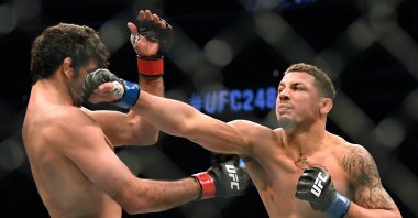 Beneil Dariush takes a punch from Drakkar Klose during UFC 248 in Las Vegas, March 7, 2020. (AFP Photo)