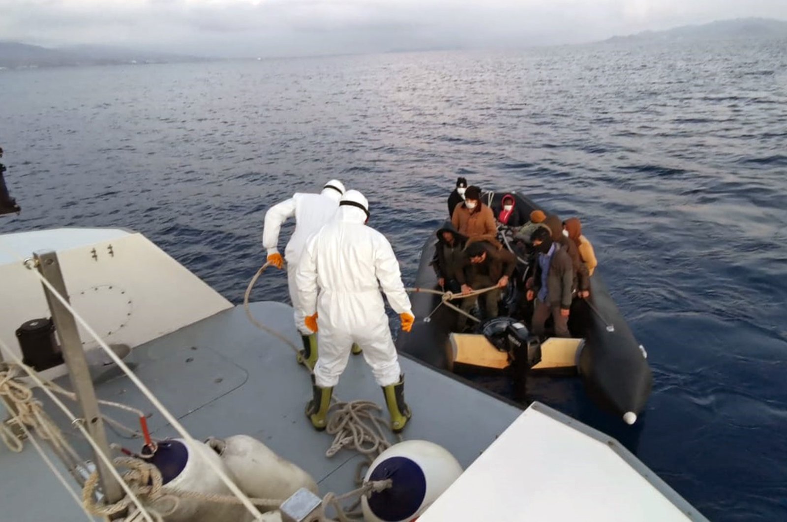 Turkish Coast Guard units help migrants pushed back by Greek counterparts near Muğla province in the Aegean Sea on Thursday, April 9, 2020 (IHA Photo)