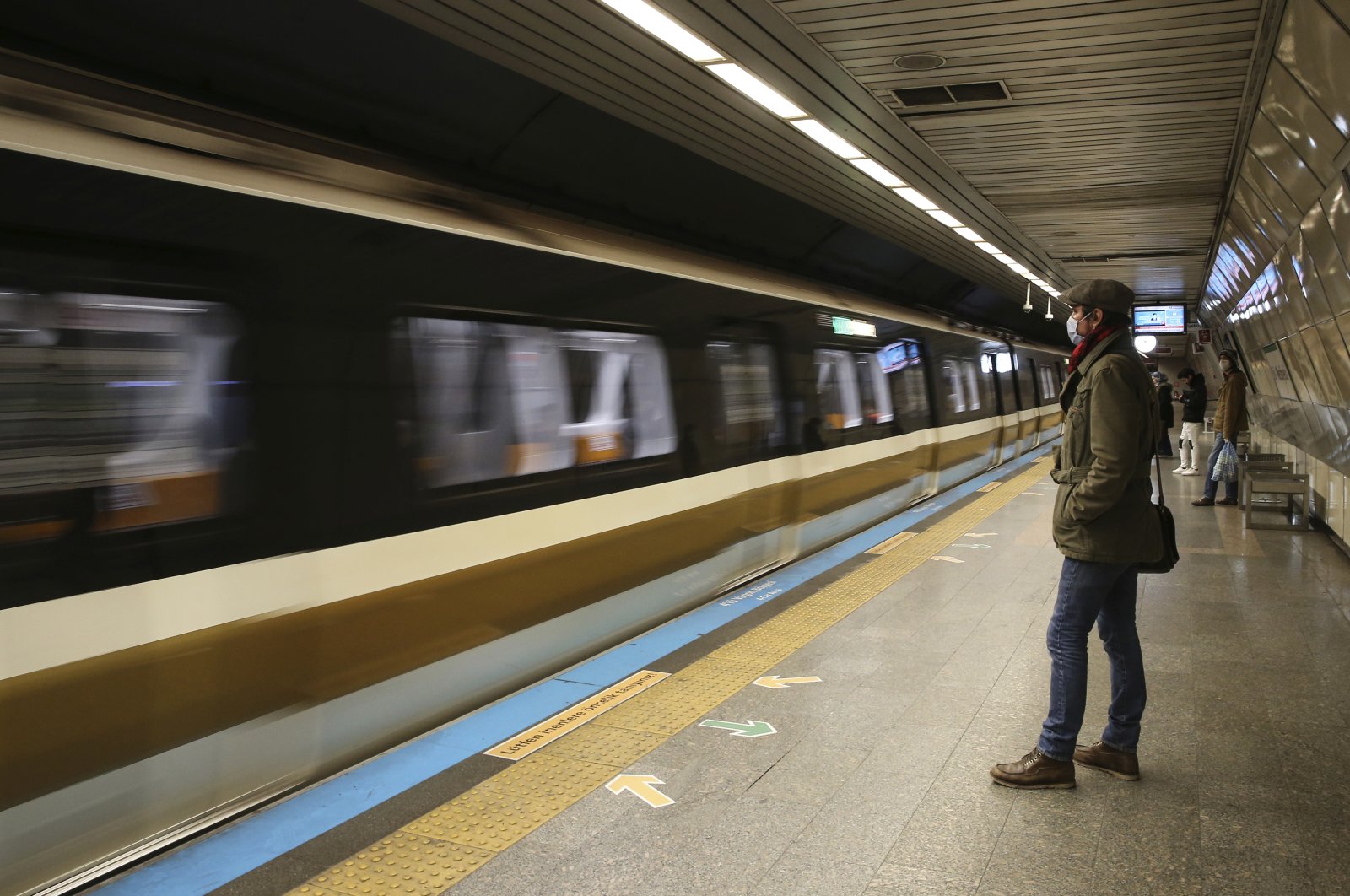A commuter wears a mask in an underground station during the coronavirus outbreak in central Istanbul, Friday, April 3, 2020. (AP Photo)