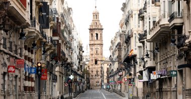 View of a church tower at the end of a deserted street in Valencia, eastern Spain, April 11, 2020. For the first time in centuries, many church bells across Spain will not be ringing on the eve of Easter Sunday, as most bell-ringers won't be able to access their churches and cathedrals due to the nationwide lockdown imposed by the government in a bid to slow down the spread of the pandemic COVID-19 disease. (EPA Photo)