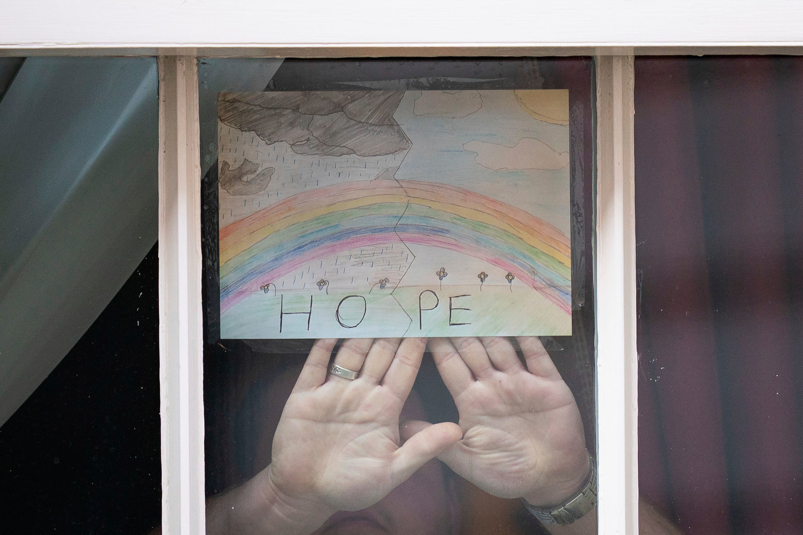A drawing of a rainbow with the word "Hope" by 6-year-old Logan is displayed in one of the windows of 10 Downing Street, London, April 9, 2020. (AP Photo)