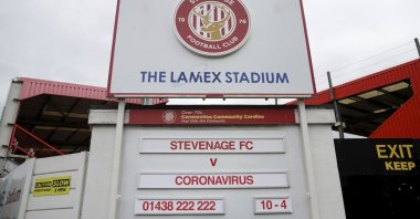 The Lamex Stadium, home of Stevenage football club, where the upcoming fixture board shows Stevenage FC v Coronavirus, Sunday, March 29, 2020. (AP Photo) 