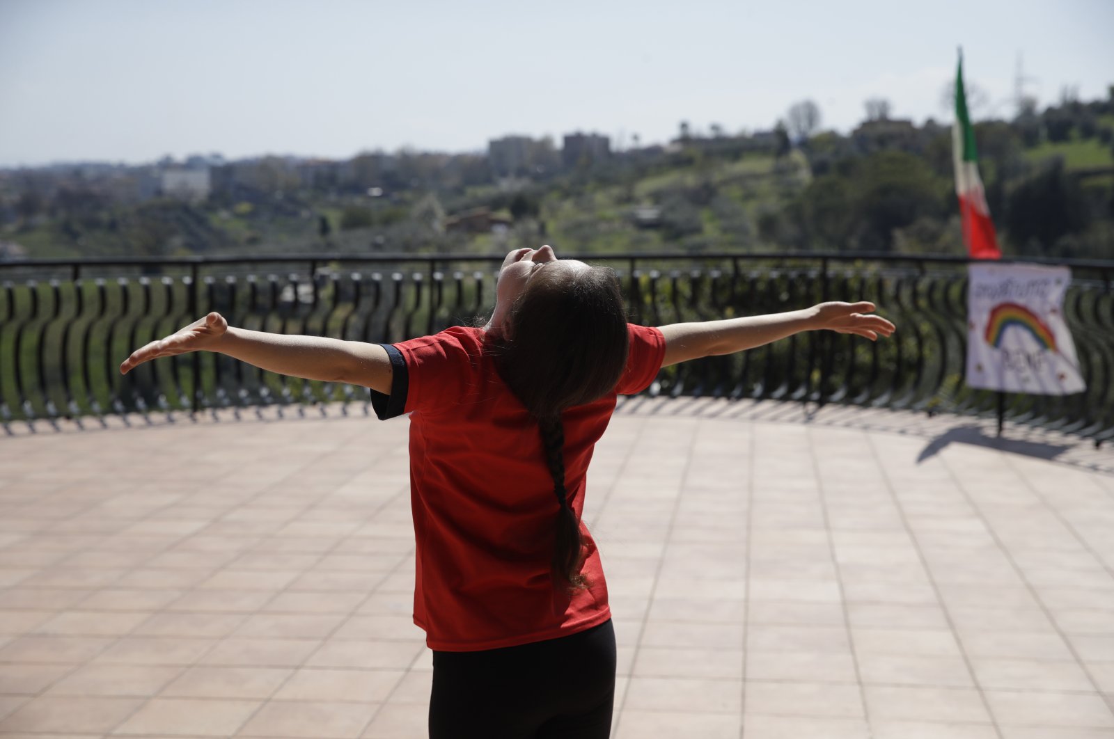 Arianna Sacripante trains on her terrace in Monterotondo, Italy, April 3, 2020. (AP Photo)