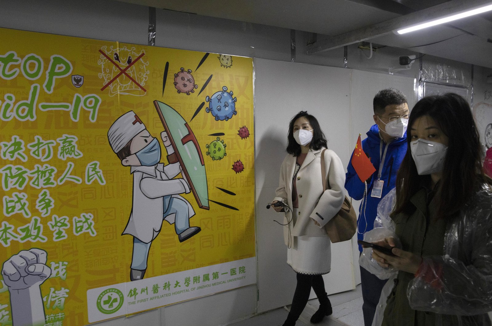 Visitors walk in the corridors of Leishenshan Hospital which was constructed in a parking lot from prefabricated modules in two weeks in Wuhan in central China's Hubei province, Saturday, April 11, 2020, as the city dealt with a rush of patients in the early days of the coronavirus outbreak. The hospital closed on April 9 but still has 14 patients, mainly elderly with underlying complications. (AP Photo)