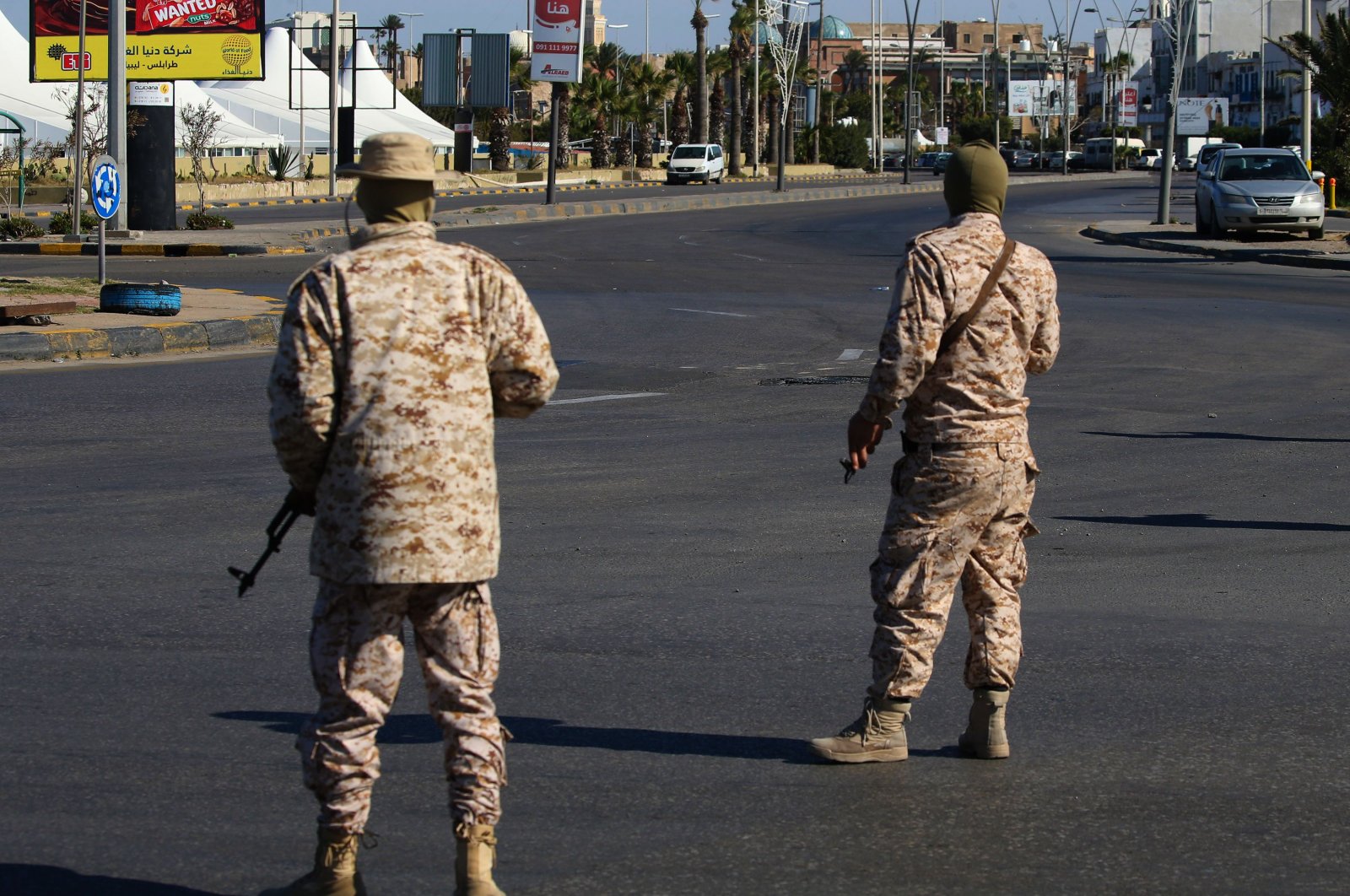 Members of the Libyan security forces man a checkpoint in the capital Tripoli, to ensure that the strict measures taken by the authorities to stem the spread of the novel coronavirus are respected, on April 10, 2020. (AFP Photo)