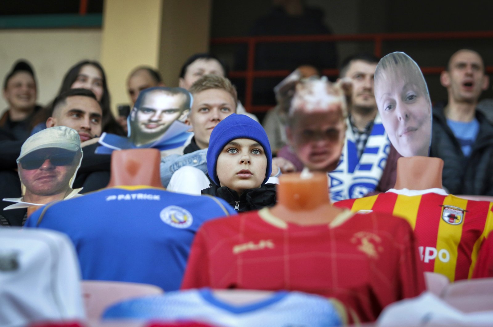Fans sit in the stands among mannequins in football uniforms with the faces of "virtual fans" who bought tickets online during the match between FC Dynamo Brest and FC Shakhter Soligorsk in Brest, Belarus, April 8, 2020. (AP Photo)