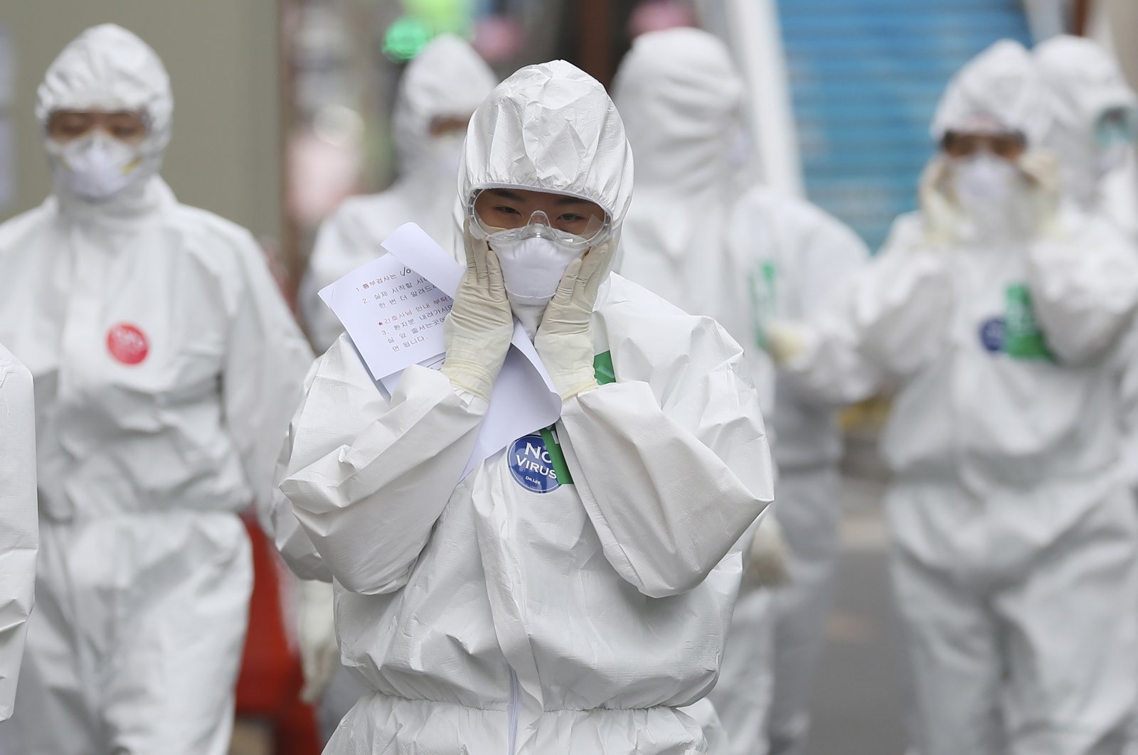 A medical staff member adjusts her face mask as she arrives for a duty shift at Dongsan Medical Center in Daegu, South Korea, Monday, April 13, 2020. (AP Photo)