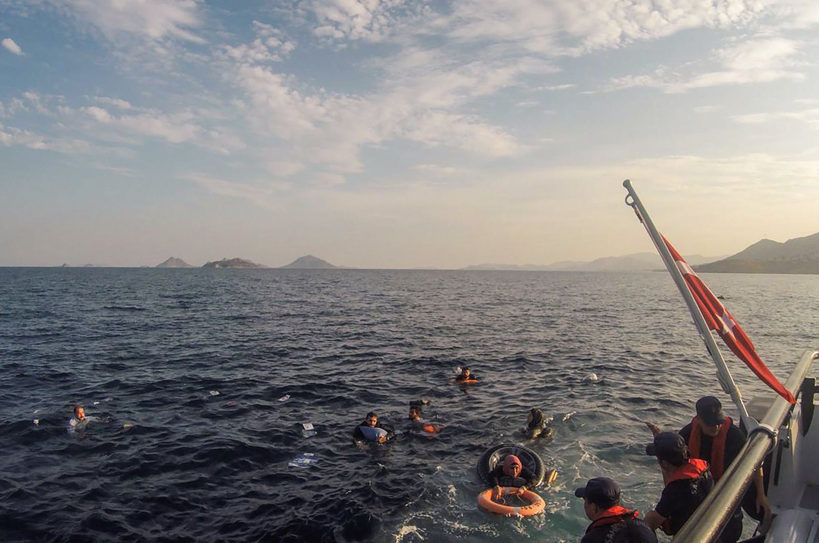 This handout picture released and taken on June 17, 2019 by the Turkish coastguard shows illegal migrants being rescued after their boat sank in the Aegean sea, off the coast of southwestern Turkey. (AFP Photo)