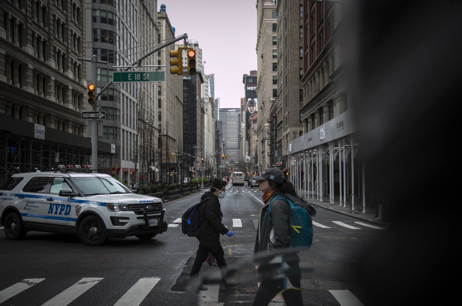 Pedestrians, one wearing a face mask, cross Park Avenue, New York City, New York, U.S., March 25, 2020. (AP Photo)