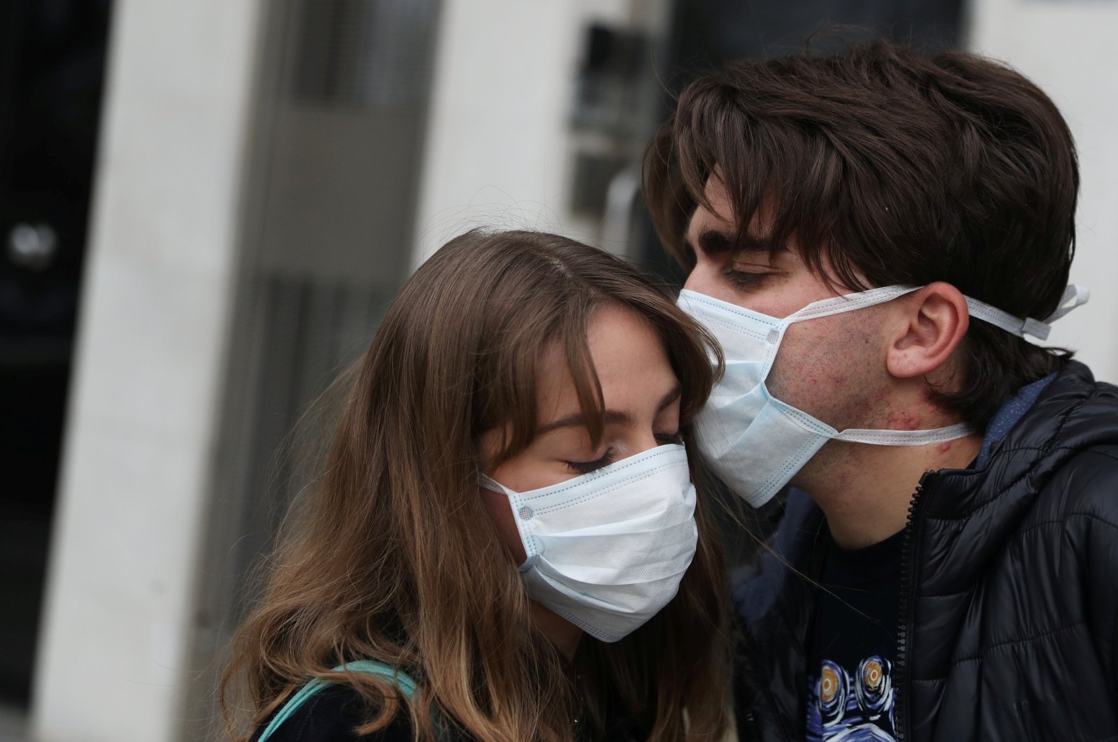 Marco Donoso del Bufalo, 20, a young man on the autism spectrum, kisses his sister Irene, 22, as they take their daily walk during the lockdown amid the coronavirus disease (COVID-19) outbreak in Madrid, Spain, April 9, 2020. (Reuters Photo)