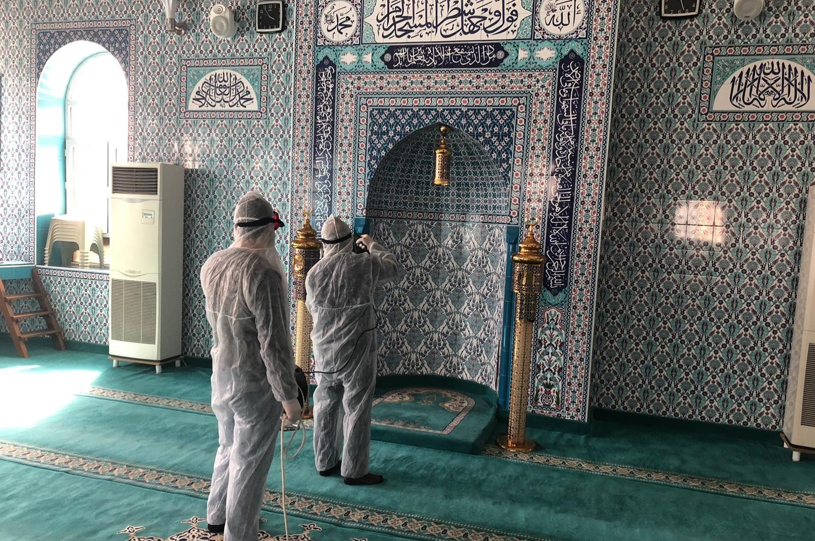 Workers disinfect a mosque in Siirt, Turkey, Tuesday, March 24, 2020. Mosques will be closed to mass tarawih prayers during Ramadan. (İHA Photo) 