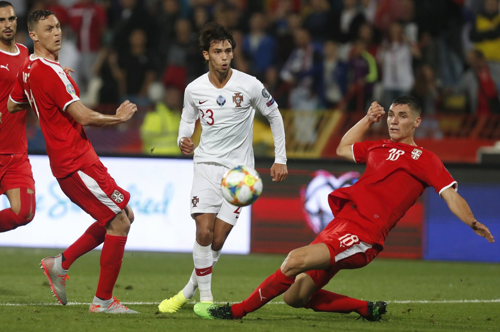 Portugal's Joao Felix, center, kicks the ball ahead of Serbia's Nemanja Matic, left, and Serbia's Nikola Milenkovic during the Euro 2020 group B qualifying match between in Belgrade, Serbia, Sept. 7, 2019. (AP Photo)
