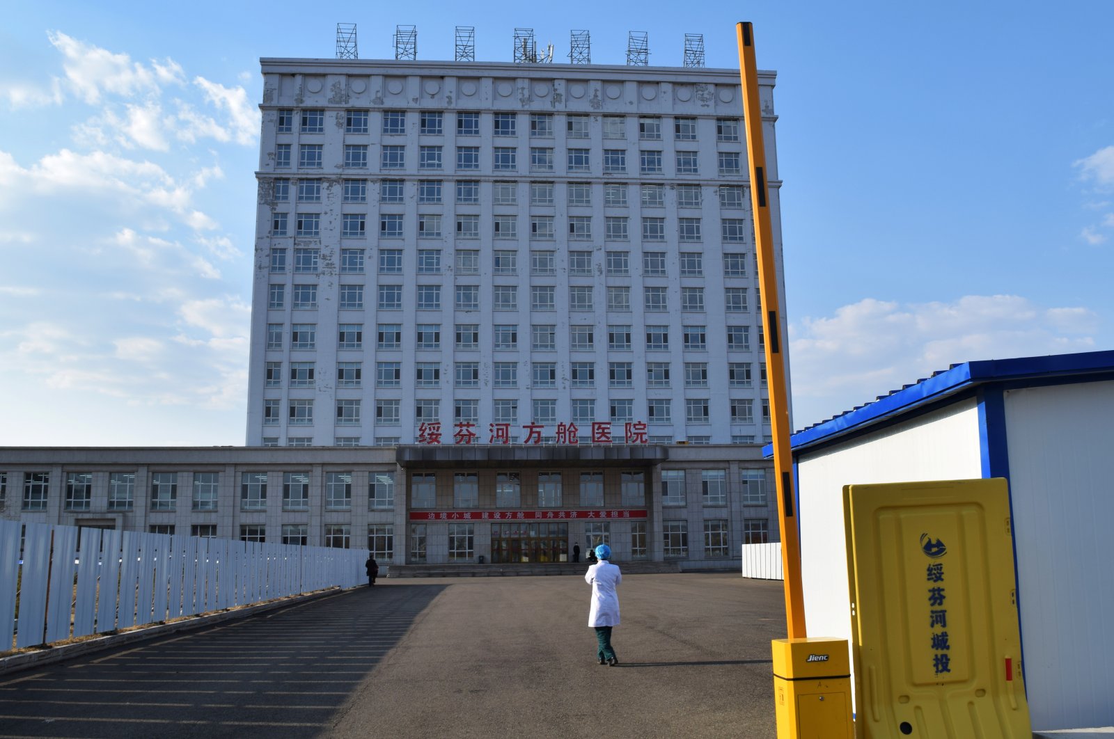 A medical worker is seen outside a makeshift hospital, which was converted from an office building, to treat patients with COVID-19 in Suifenhe, a city in Heilongjiang province on China's border with Russia, April 13, 2020. (REUTERS Photo)