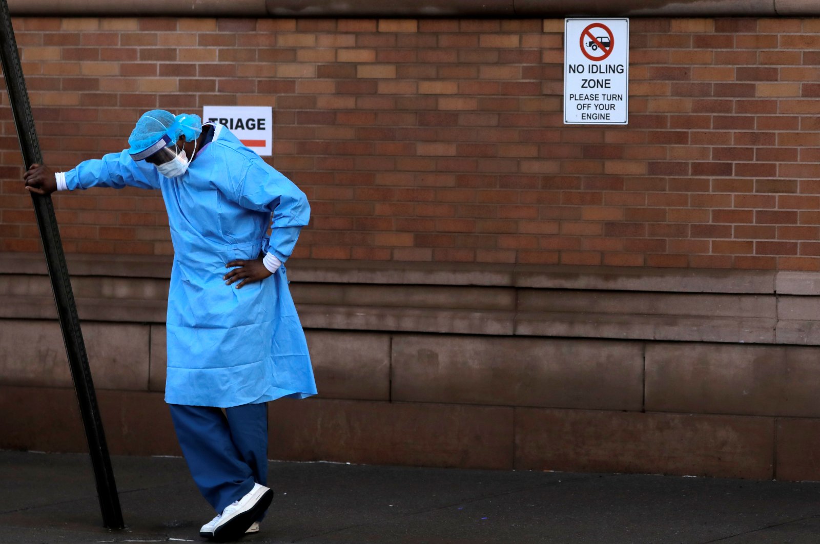 A healthcare worker takes a break outside the emergency center at Maimonides Medical Center during the outbreak of COVID-19 in the Brooklyn borough of New York, April 13, 2020. (Reuters Photo)