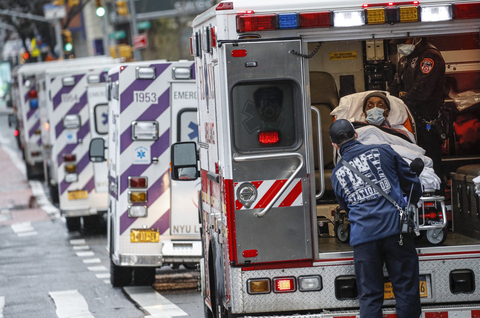 A patient arrives in an ambulance cared for by medical workers wearing personal protective equipment due to COVID-19 concerns, NYU Langone Medical Center, Monday, April 13, 2020, in New York (AP Photo)