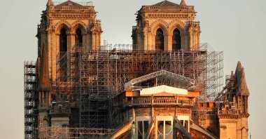 This picture taken on April 14, 2020 shows the Paris' Cathedral Notre Dame at the sunrise on the eve of the first anniversary of the violent fire who destroyed a large part of the monument, on the twenty-nineth day of a lockdown in France to stop the spread of the  COVID-19. (AFP Photo)
