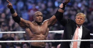 Donald Trump raises the arm of wrestler Bobby Lashley after he defeated Umaga at Wrestlemania 23 at Ford Field, Detroit, April 1, 2007. (AP Photo)