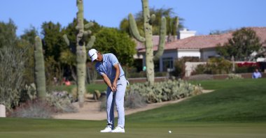 Xinjun Zhang putts on the second green during the final round of the Waste Management Phoenix Open PGA Tour golf event in Scottsdale, Arizona, U.S., Feb. 2, 2020. (AP Photo)