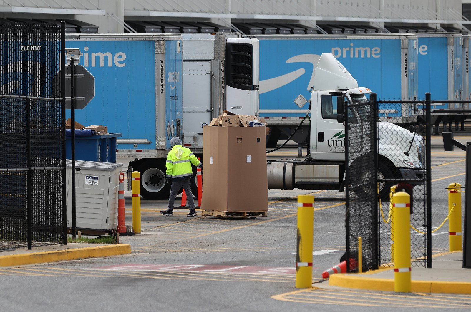 A worker moves boxes at the 1.2 million-square-foot BWI2 Amazon Fulfillment Center employing about 2500 workers in the Chesapeake Commerce Center April 14, 2020 in Baltimore, Maryland. (AFP Photo)