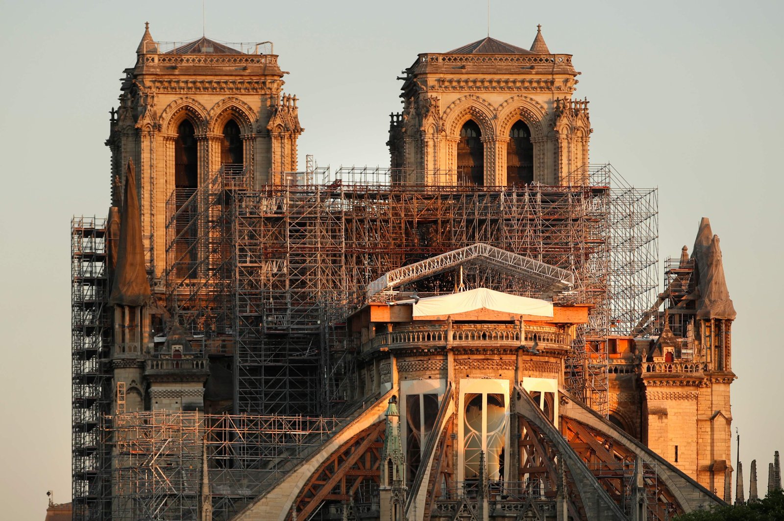 This picture taken on April 14, 2020 shows the Paris' Cathedral Notre Dame at the sunrise on the eve of the first anniversary of the violent fire who destroyed a large part of the monument, on the twenty-nineth day of a lockdown in France to stop the spread of the  COVID-19. (AFP Photo)