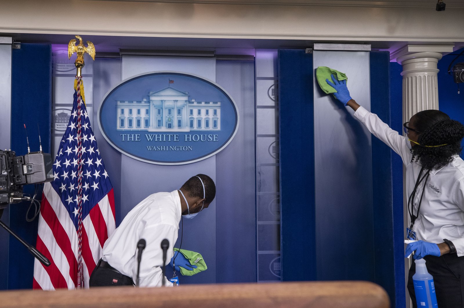A cleaning crew wipes down surfaces before U.S. President Donald Trump speaks about the coronavirus in the James Brady Press Briefing Room at the White House, Washington, April 13, 2020. (AP Photo)