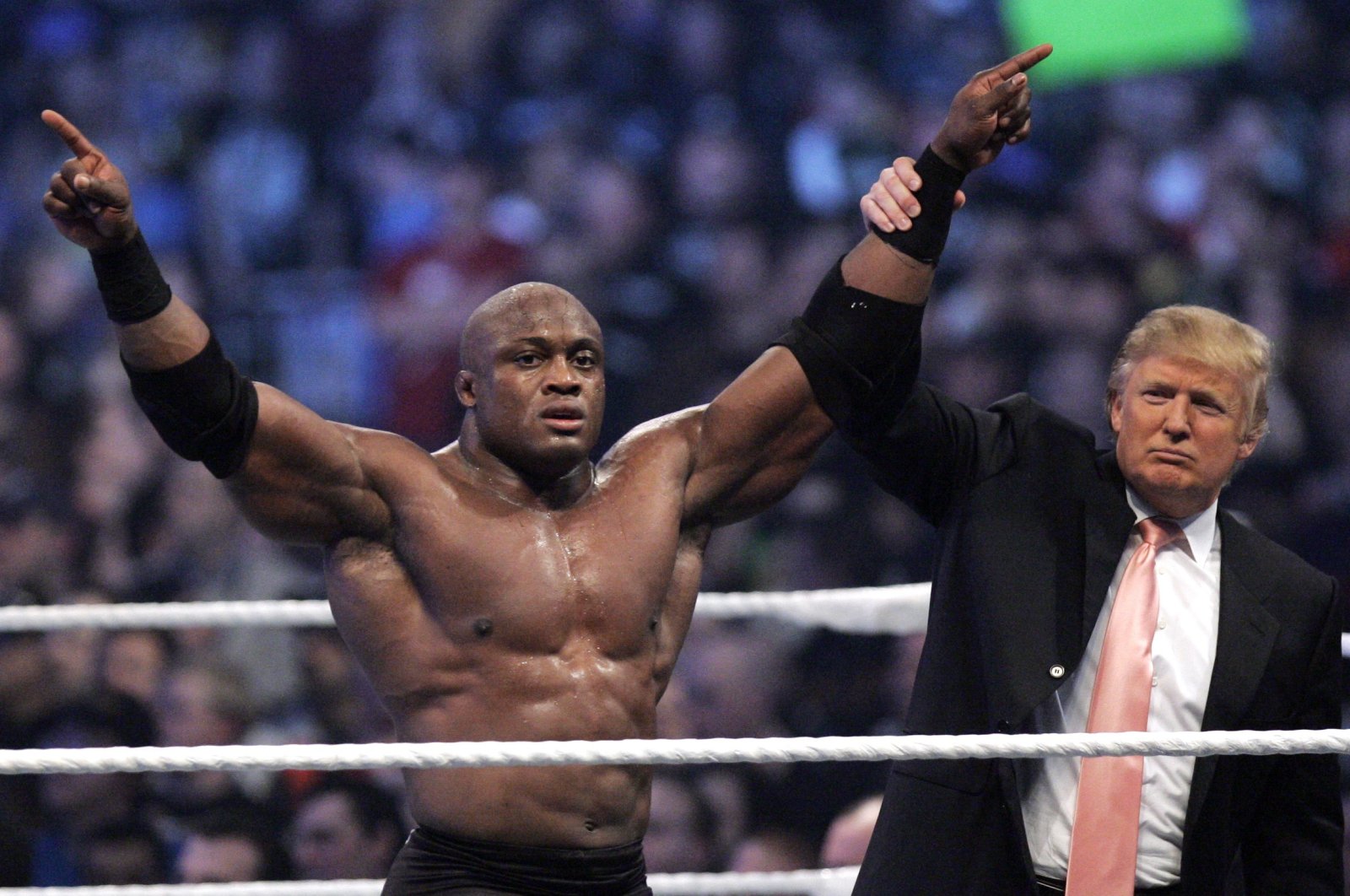 Donald Trump raises the arm of wrestler Bobby Lashley after he defeated Umaga at Wrestlemania 23 at Ford Field, Detroit, April 1, 2007. (AP Photo)