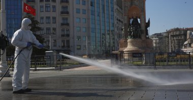 Workers clean and disinfect surfaces in the city's iconic Taksim Square amid the coronavirus outbreak, Istanbul, Turkey, April 12, 2020. (AP Photo)