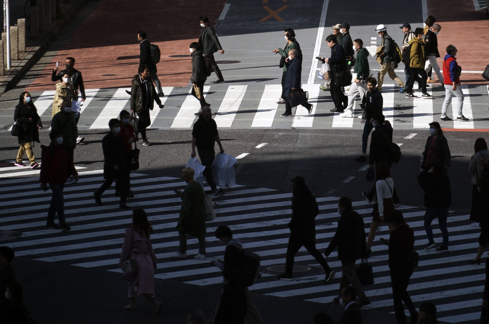Fewer than usual people at Shibuya Scramble Crossing are seen in Tokyo, Japan, Tuesday, April 14, 2020. (AP Photo)