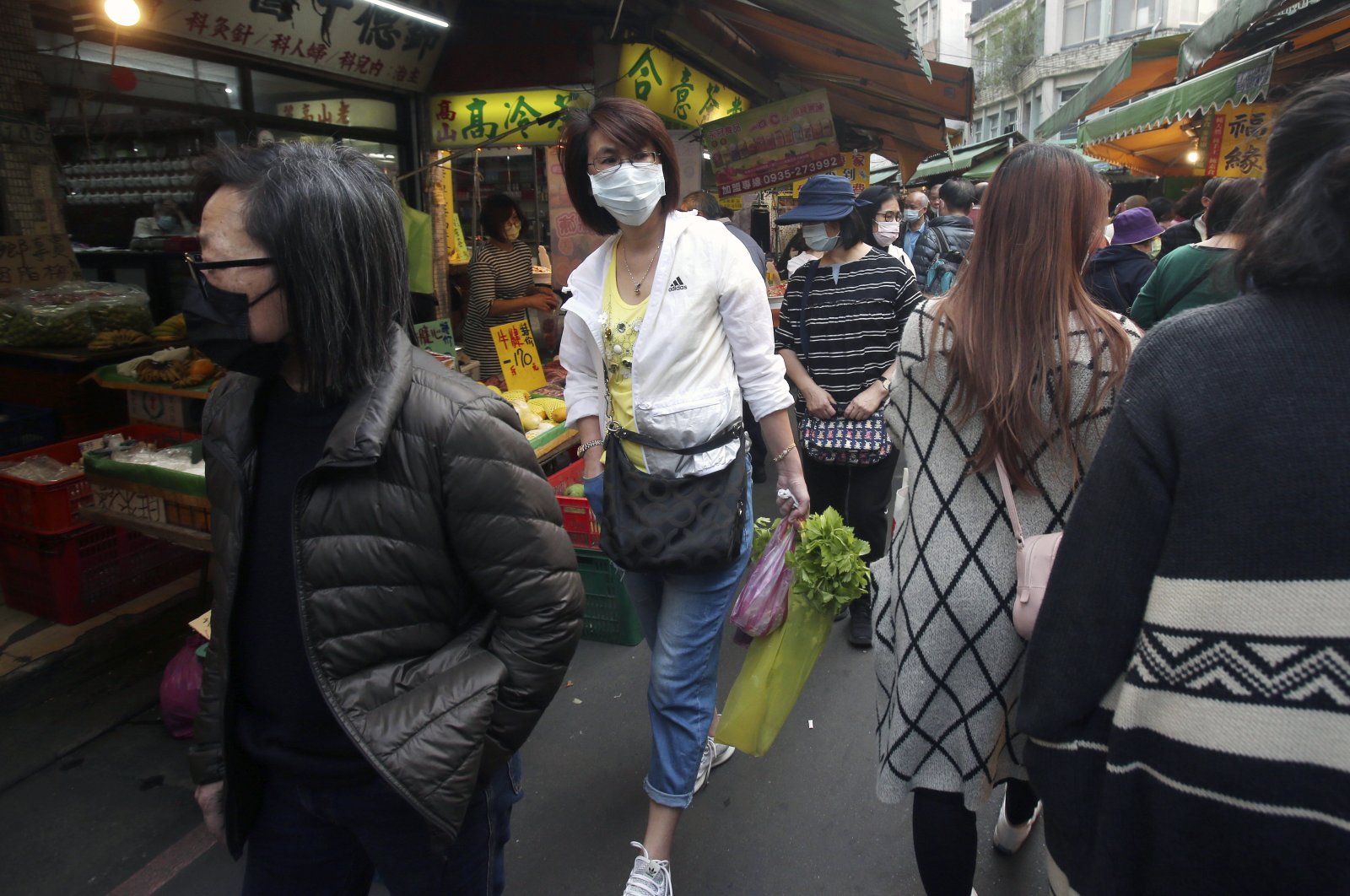 People wear face masks to help curb the spread of the coronavirus as they shop at a market in Taipei, Taiwan, Tuesday, April 14, 2020. (AP Photo)
