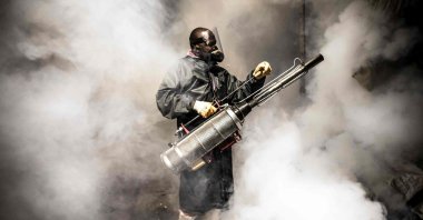 A member of a privately funded nongovernmental organization fumigates and disinfects streets and the stalls at Parklands City Park Market to help curb the spread of COVID-19, Nairobi, Kenya, April 15, 2020. (AFP Photo)