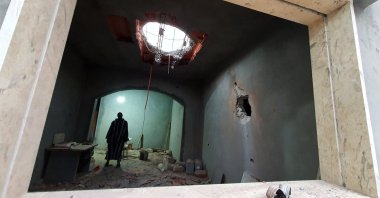 A Libyan man stands at the site of shelling on the residential area of Arada in the capital Tripoli, Tuesdaym April 14, 2020. (AFP)