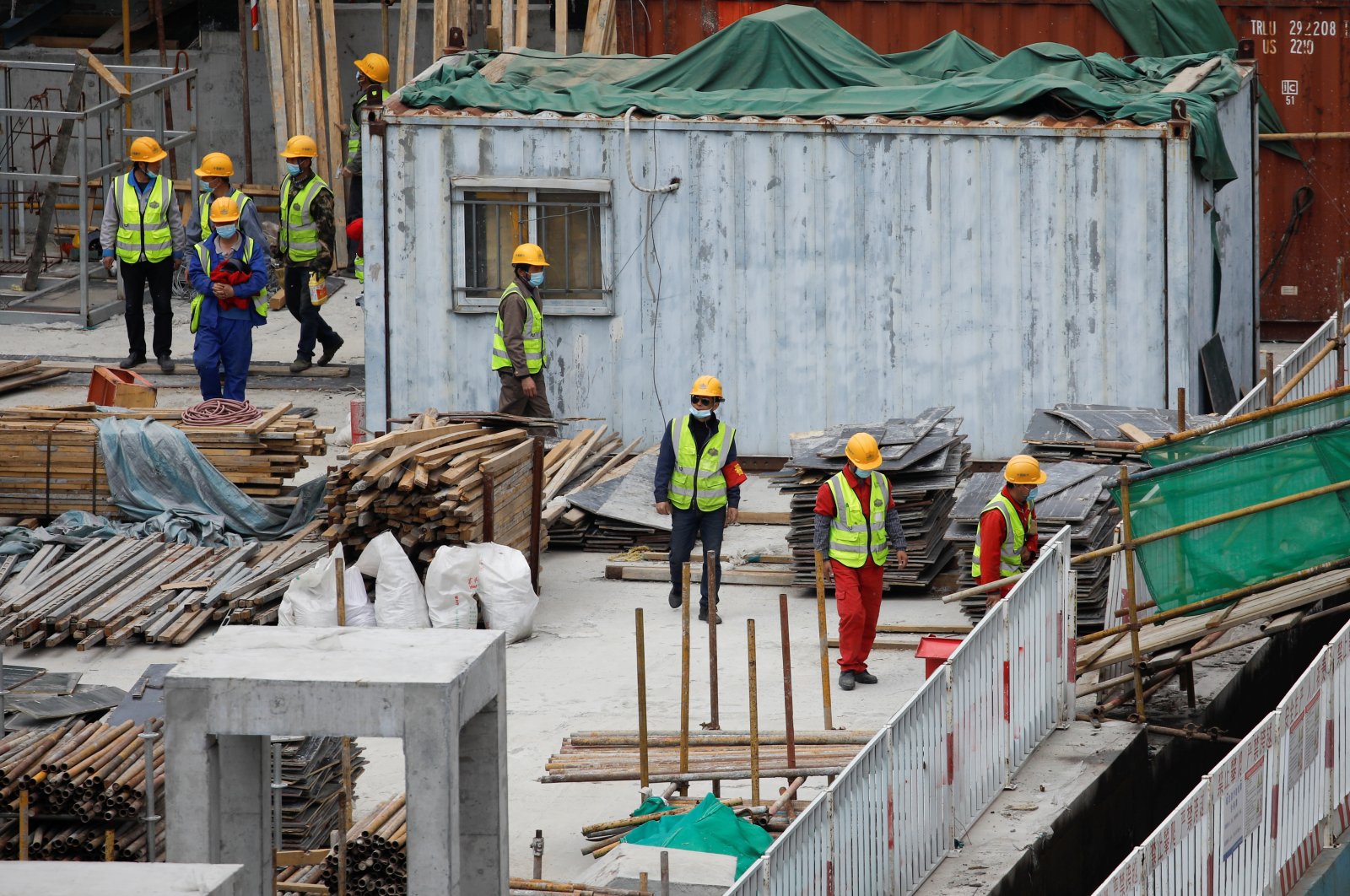 Workers wearing face masks walk at a construction site amid COVID-19 outbreak, Beijing, China, April 17, 2020. (Reuters Photo)