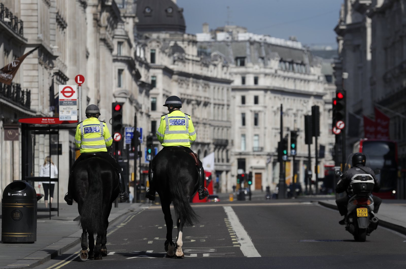 Mounted police officers patrol along a deserted Regent Street in London, as the U.K. is in lockdown to help curb the spread of the coronavirus, April 15, 2020. (AP Photo)