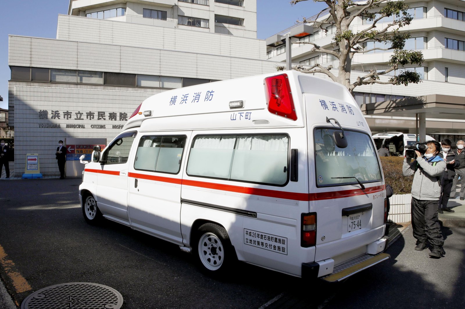 In this Feb. 5, 2020, photo, an ambulance carrying a passenger onboard cruise ship Diamond Princess arrives at a hospital in Yokohama, near Tokyo. (Kyodo News via AP)