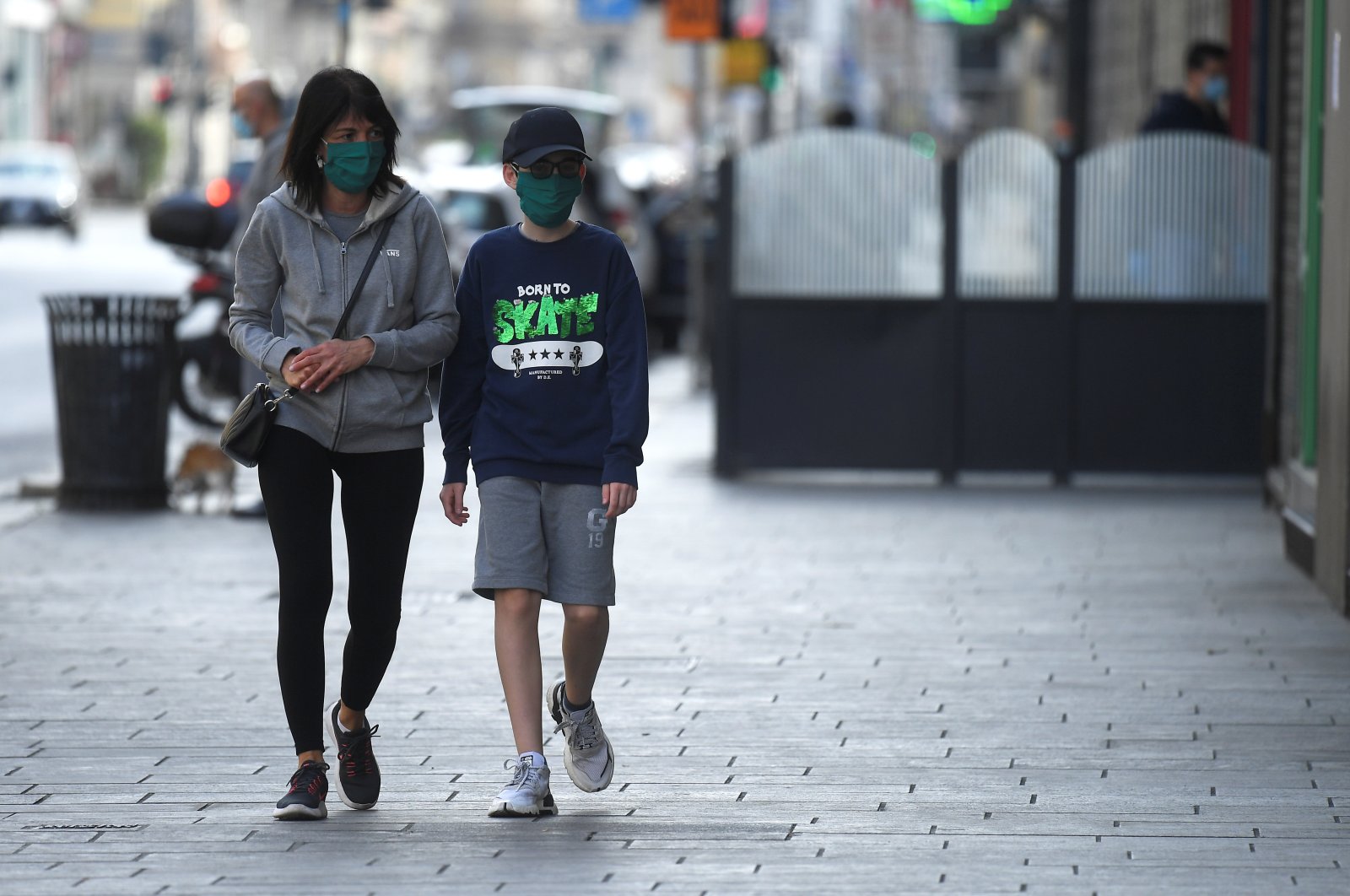 People wearing face masks walk on a street, amid the coronavirus disease (COVID-19) outbreak, in Milan, Italy April 18, 2020. (Reuters Photo)