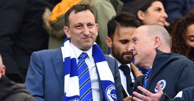 Tony Bloom (L) takes his seat before a Premier League match in Brighton, England, April 27, 2019. (AFP Photo)