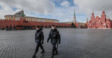 Police officers wearing protective masks walk on the Red Square in front of the Kremlin in Moscow, Russia, 17 April 2020. (EPA-EFE/YURI KOCHETKOV Photo)
